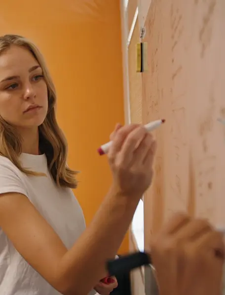 Our account manager Gabi writing something on the whiteboard